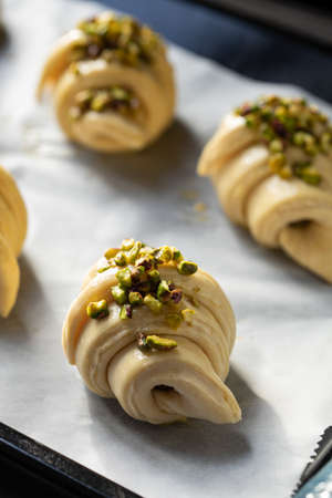Close up of unbaked butter croissants on baking sheet