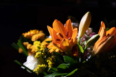 Autumn bouquet in yellow and orange colors on dark backgroundの写真素材