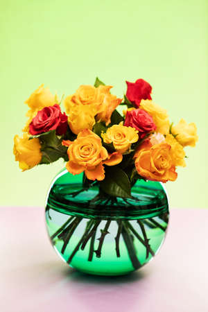 Bouquet of yellow and pink roses in vaseの写真素材