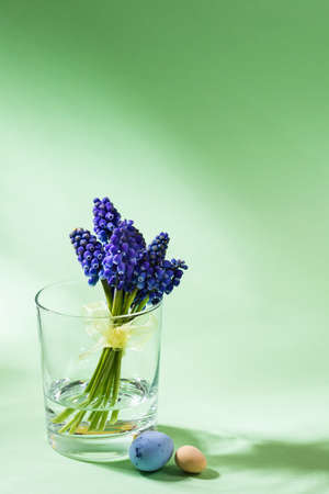 Easter composition with bluebells in vase and eggs