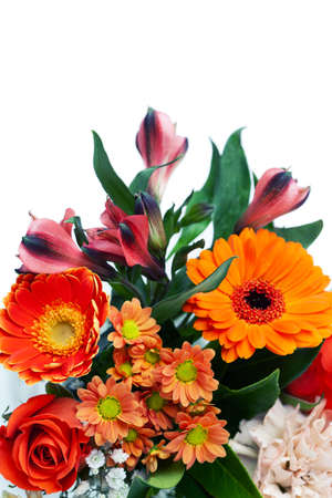 Mixed bouquet of red and orange flowers on white backgroundの写真素材