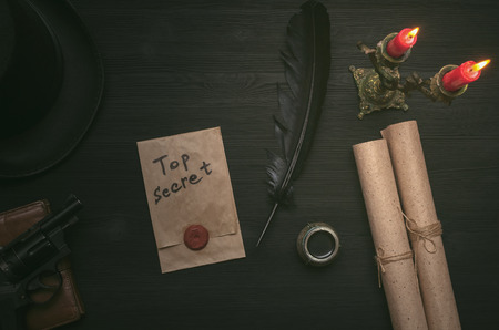 Top secret message document. Forbidden information. Detective agent desk table concept background. Secret agreement.の写真素材