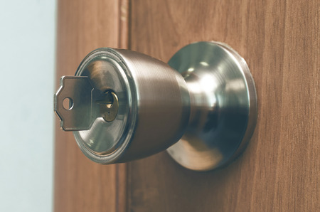 Key in the door lock. Doorknob with key background. 