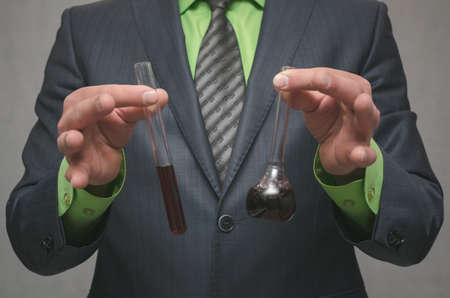 The scientist mixes the reagents in the beakers. Presentation of a new medical product. The chemistry teacher. Chemical industry. Pollution test.の写真素材