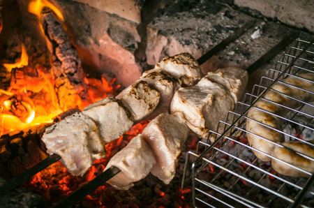 Barbecue meat steaks on the grill with flames. Meat on the coals. barbecue vacation concept close up.の写真素材