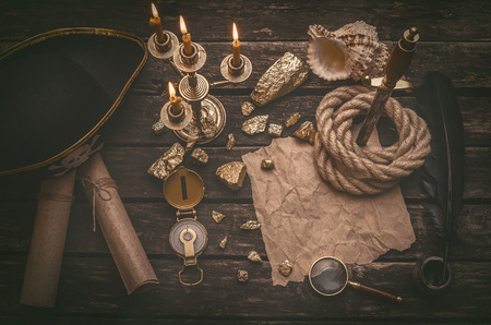 Pirate hat, golden nuggets and treasure map crumpled parchment with copy space, dagger, compass and...