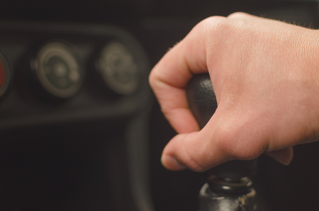 Driver hand on gear shift knob. Car travel concept.の写真素材