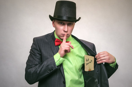 Secret documents letter with compromising evidence in hands of secret detective agent isolated on white. Secret service. The spy concept.の写真素材