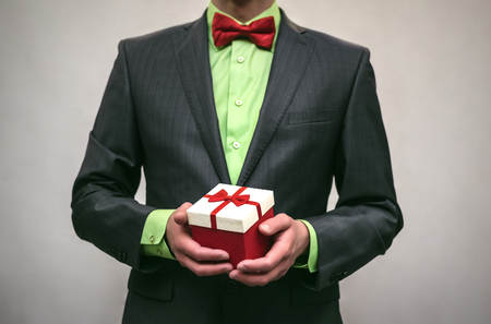 Man in suit holds in hands present box trophy isolated on white. Award ceremony.の写真素材