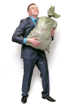 Cleaner man with garbage trash bag isolated on white background. Cleaning agency concept. Waste recycling business.の写真素材