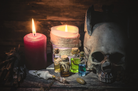 Magic potion and human skull on magic table background. Witchcraft concept.の写真素材