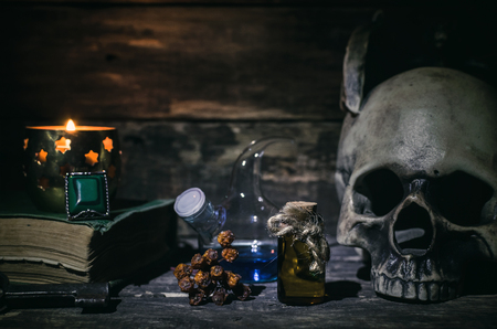 Magic potion and human skull on magic table background. Witchcraft concept.の写真素材