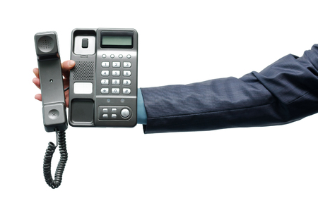 Telephone in the male hand isolated on the white background.の写真素材