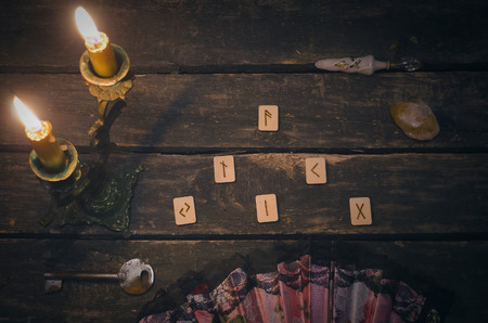 Magic divination runes on fortune teller desk table background. Futune reading concept.