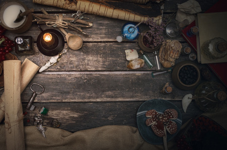 Wizard table with various magic accessories and ingredients. Witchcraft. Herbal alternative medicine.の写真素材