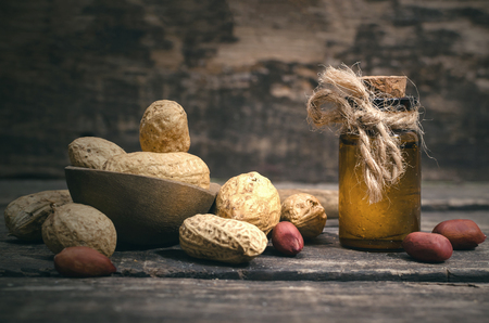 Peanut oil in the bottle on the wooden table background.の写真素材