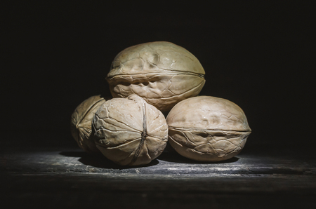 Heap of walnuts on the dark background.の写真素材