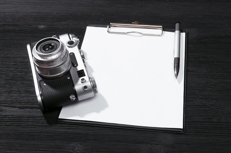 Shot list mockup. Photo session contract template. Vintage film photo camera and blank paper page on...