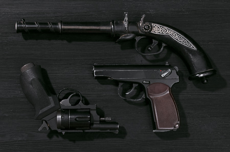 Guns on black wooden table background.の写真素材