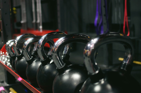 Group of kettlebells on the rack in the gym background.の写真素材