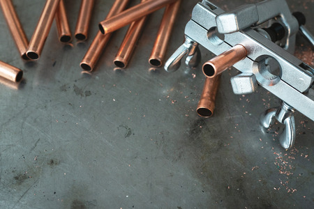 Pipe rammer tool on a fitter workbench. Pipework concept background with copy space.の写真素材