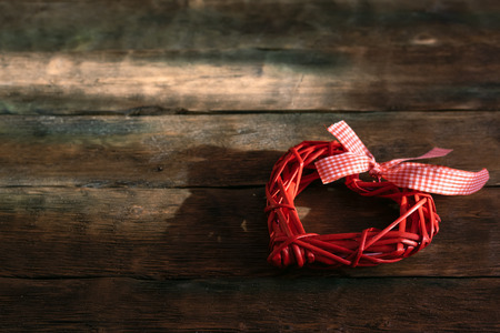Red heart on a wooden board background with copy space. Saint Valentine day.の写真素材