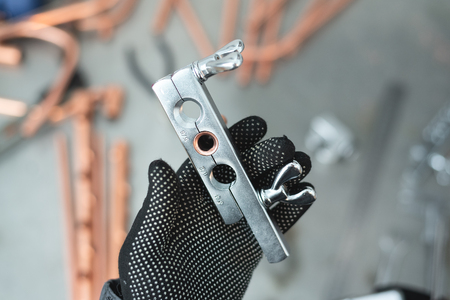 Engineer is holding in hands a pipe rammer tool. Pipework.の写真素材