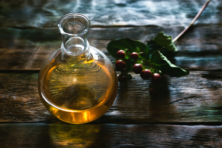 Herbal medicine essential oil and dry herb on a table. Witchcraft.の写真素材