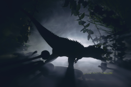Tyrannosaurus dinosaur is hunting in a night jungle, concept of jurassic period.の写真素材