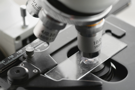 Blurred microscope lens close up photo. Examination of samples under the microscope abstract background.の写真素材