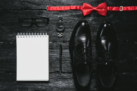 Blank page notepad and pen on black table background. Business plan or tips mockup. To do list template.の写真素材