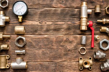 Plumbing flat lay background with copy space. Work tools and pipeline parts on plumber workbench.