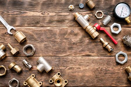 Plumbing flat lay background with copy space. Work tools and pipeline parts on plumber workbench.
