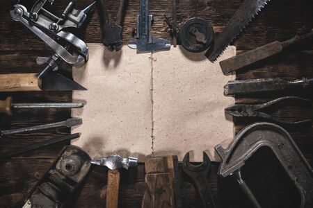 To do list mock up. Construction handbook with blank pages and old construction tools on a wooden workbench flat lay background. Carpentry. Woodwork.の写真素材