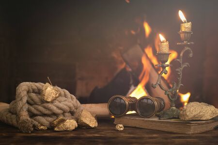 Treasure hunt. Pirate concept. Adventurer table with treasure gold,  diary book, binoculars, rope...