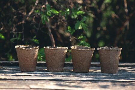 Group of flower pot with a soil on a wooden garden table. Gardening abstract background.の写真素材