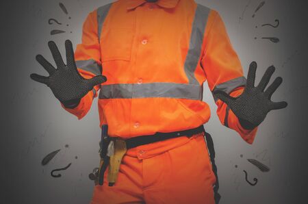 Guilty builder worker justifies and spreads his hands isolated on blue background. Construction...