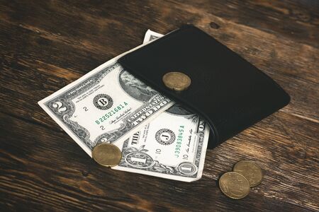 Empty wallet with few dollars on a table. Tight of money. Lack of money. Financial problems....