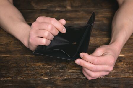 Empty wallet in a male hands. Tight of money. Lack of money. Financial problems. Bankrupt.