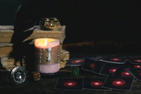 Tarot cards and magic books on fortune teller desk table background. Futune reading concept. Divination.の写真素材