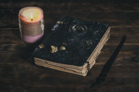 Book of magic and a magic wand on the magician table. Witchcraft.の写真素材