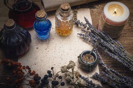 Magic potion ancient recipe scroll with copy space. Alternative herbal medicine. Shaman table with copy space. Druidism concept. Witch doctor desk background.の写真素材