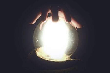 Fortune teller reading future with crystal ball. Seance concept.の写真素材