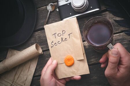 Top secret documents in the envelope in the hands of detective agent. Security.の写真素材