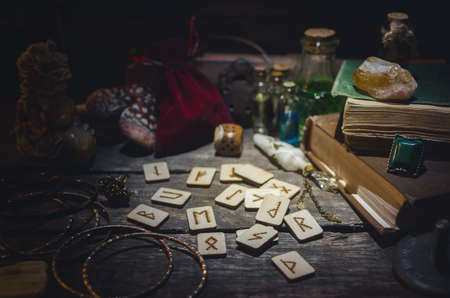 Runes for divination on fortune teller desk table background. Futune reading concept.の写真素材