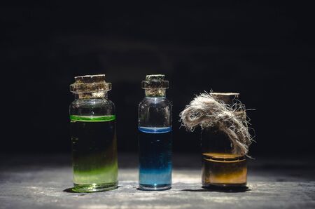 Various magic potions or colorful essential oils in the bottles on the table.の写真素材