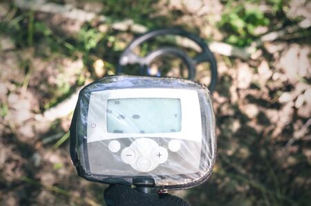 Metal detector and coin finder. Treasure hunting concept. In searching of ancient relics.の写真素材