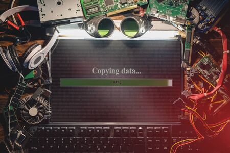 Illegal data copying concept. Flat lay computer and computer parts on the table.の写真素材