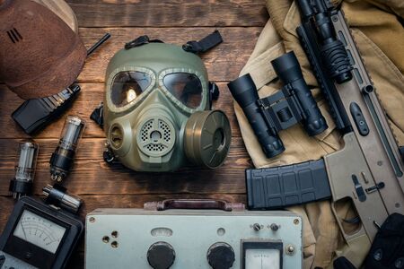 Post apocalypse soldier equipment on the table background.