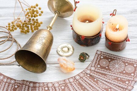 Tarot cards and golden goblet on white table of fortune teller. Divination. Future reading concept.